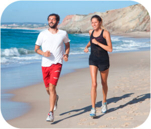 Men and women jogging at the beach